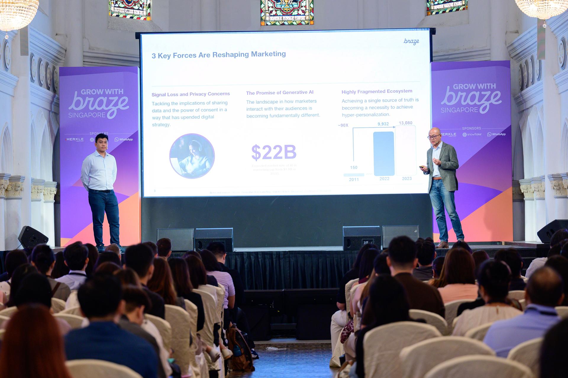 a man is giving a presentation in front of a crowd of people .