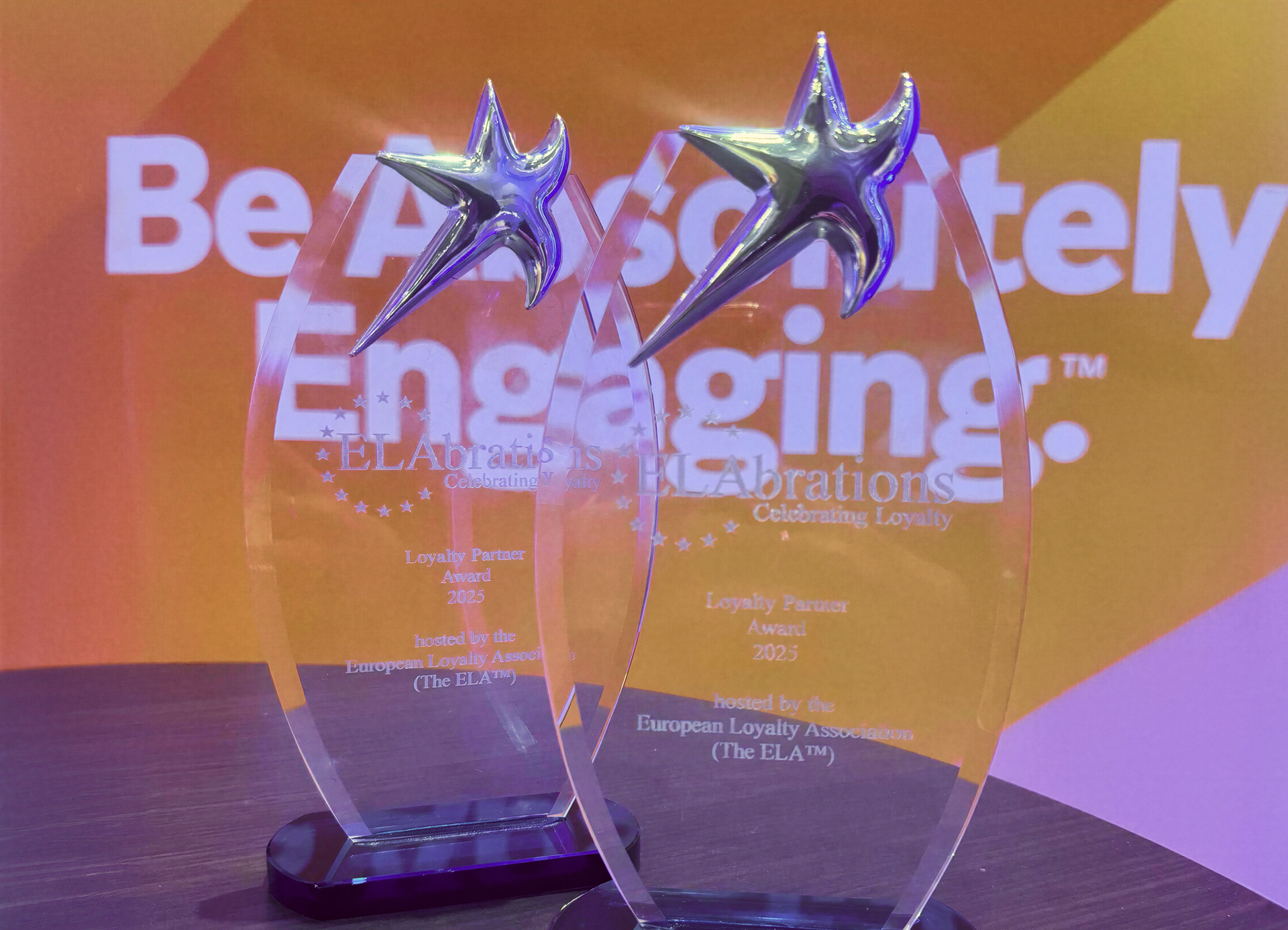 Two clear acrylic awards with silver stars, engraved "Loyalty Partner Award 2023" from the European Loyalty Association.